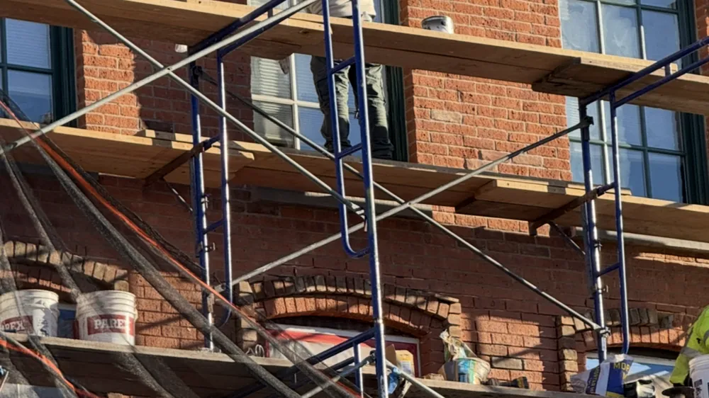 Scaffold access erected against a brick elevation during facade repair work