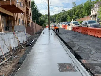 Sidewalk fresh pour street, sidewalk and curb work in New York